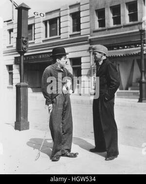 CHARLES CHAPLIN (1889-1977) English film actor with Jackie Coogan on the set of Modern Times in 1935 Stock Photo