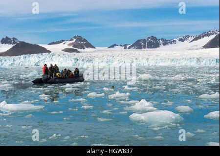 Zodiac with tourists observing a seal in front of Lilliehook glacier in Lilliehook fjord a branch of Cross Fjord, Spitsbergen Island, Svalbard archipelago, Norway Stock Photo