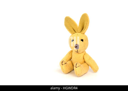 Little brown Plush Rabbit seated looking at the camera Stock Photo