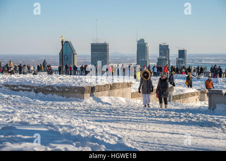 Montreal, CA - 1 January 2017: Montreal Skyline and People at the Kondiaronk Belvedere on Mount Royal during the winter season. Stock Photo