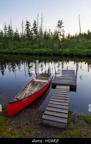 A canoe and boat dock on the Cold Stream 'deadwater' above Upper Cold Stream Falls in Maine's Northern Forest. Johnson Mountain Township. Stock Photo