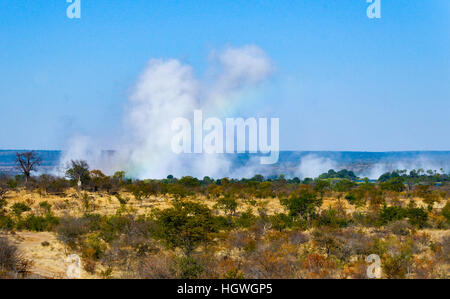 Distant view of water vapor rising from Victoria Falls, Zambia Stock Photo