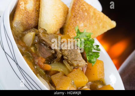 An English pub/restaurant bowl of Beef Casserole served with fried bread croutons.