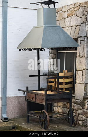 Big barbecue in the corner of the house placed in the backyard Stock Photo