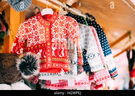 Various Colorful Knitted Traditional European Warm Clothes Sweaters At Winter Christmas Market. Souvenir From Europe. Stock Photo