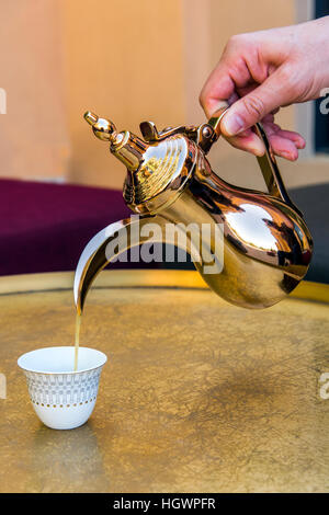 Coffee served with traditional Arabic coffee pot in a coffee place, Al Ain, United Arab Emirates Stock Photo
