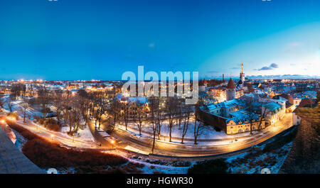 Tallinn, Estonia. Panorama Of Old Part Of Traditional Medieval Houses, Old Narrow Streets And Ancient Towers With Fortification Walls In Evening, Nigh Stock Photo