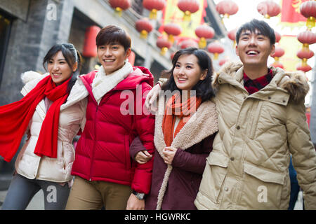 Young friends walking together on street Stock Photo