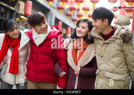 Young friends walking together on street Stock Photo