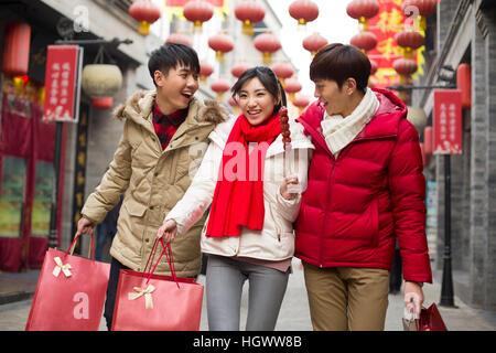 Happy young friends shopping for Chinese New Year Stock Photo