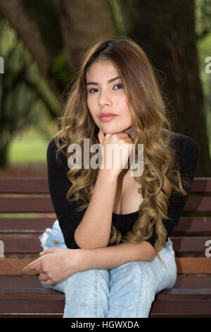 Isolated young casual woman thinking Stock Photo - Alamy