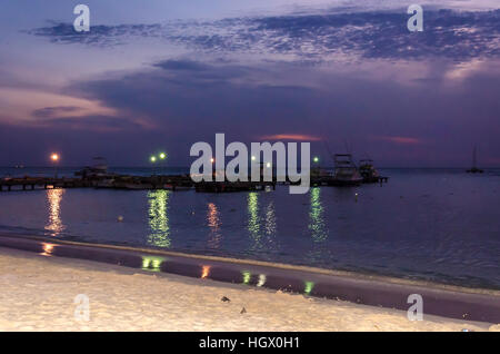 Aruba, Caribbean - September 26, 2012: Sunset with anchored sail boats on sea by the bay. The image was taken in Aruba, in the Caribbean Sea. Stock Photo