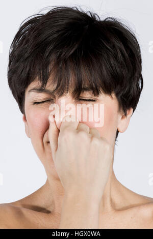 Woman holding her nose Stock Photo