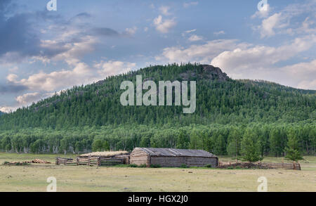 Barn and corral,  on the Mongolian grassland with hills in the background, Mongolia, Asia Stock Photo