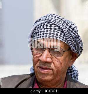 Head picture of a man wearing an Arabic scarf in front of the Taj Mahal in India Stock Photo