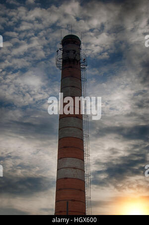 brick factory chimney. Tube for propulsion bricks in the furnace. Pipe on a background sunset Stock Photo