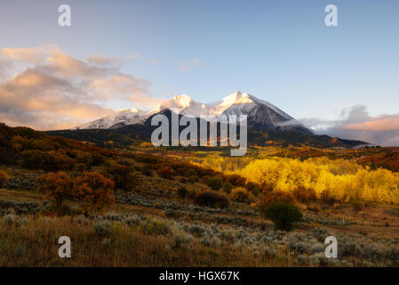 Sunrise at Twin mountain View of Mount Sopris and Mount Elk with Fall color and morning mist, Snowmass Maroon Bells Wilderness area, Colorado Stock Photo