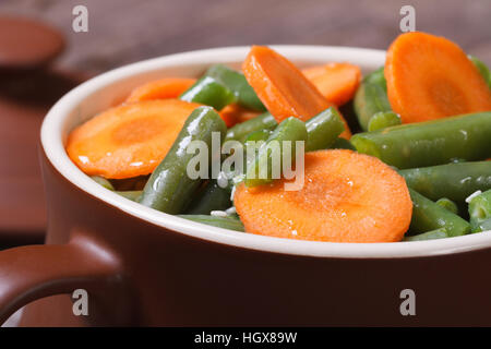 Green beans and carrots in a pot for baking closeup Stock Photo