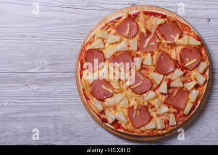 Hawaiian pizza with pineapple and ham on the table. top view Stock Photo
