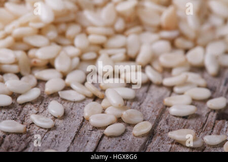 Sesame seeds scattered on an old wooden table. macro. horizontal Stock Photo