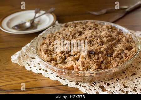 Fresh homemade dutch apple crumb dessert pie on doily with utensils Stock Photo