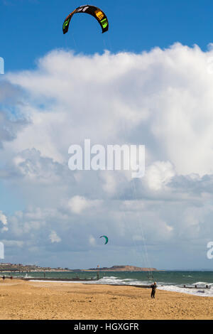 Kite surfers make the most of the blustery conditions at Bournemouth beach, Dorset UK in October.- kitesurfer kitesurfing kite surfing kiteboarder Stock Photo