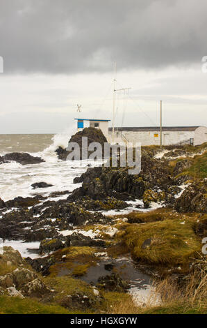A winter storm batters the County Down coast in Ireland and the yacht club control tower is hammered by the waves and spray Stock Photo