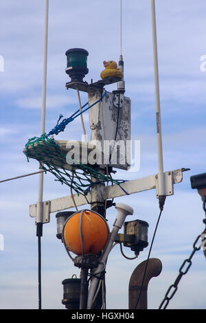 Close up shots of a small trawler mast with navigation lights, ropes, markers and beacons Stock Photo