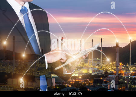 Double exposure of engineer using digital tablet pc assistance control machine to manufacturing in factory. Smart factory concept. Stock Photo