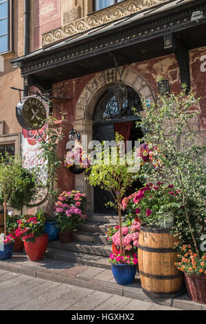 Colourful plants outside the entrance to U Fukiera restaurant, Rynek Starego Miasta 27 Warsaw, Poland Stock Photo