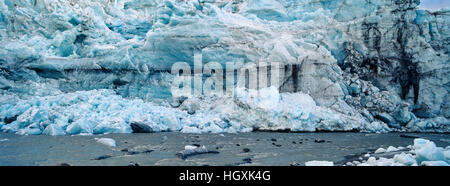 A river flowing along the fracture zone of an enormous glacier. Stock Photo