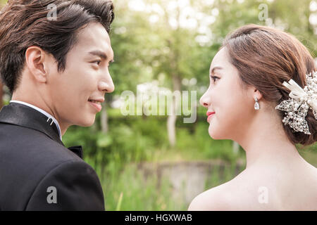 Portrait of groom and bride smiling at each other Stock Photo