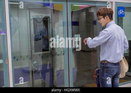 Businessman waiting for train checking time Stock Photo