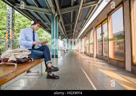 Businessman using tablet waiting for train Stock Photo