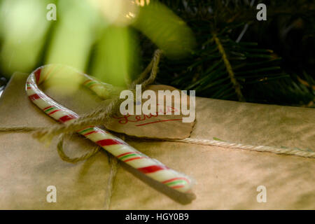 Christmas gift under tree with candy cane Stock Photo