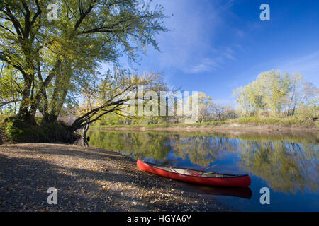 A canoe rests on the banks of he Connecticut River in Maidstone, Vermont. Stock Photo