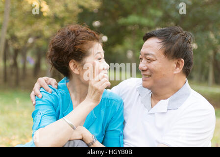 Happy old couple posing at autumn park Stock Photo