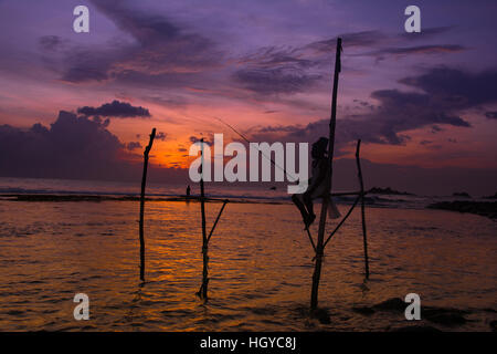 Traditional Sri Lankan stilt fishermen Stock Photo