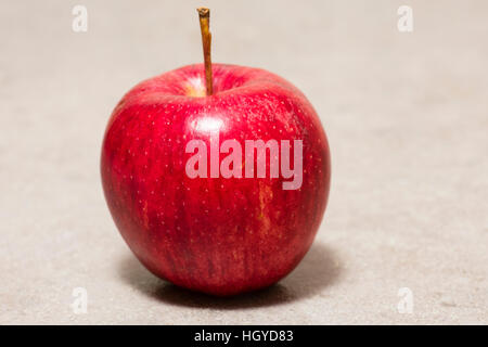 Red apple on neutral worktop Stock Photo