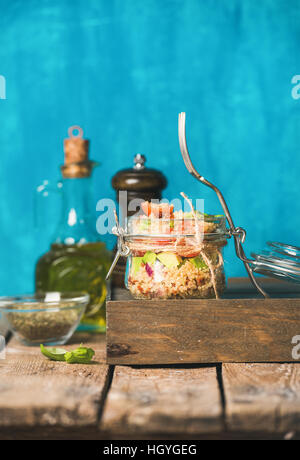 Healthy homemade quinoa salad with tomatoes, avocado and fresh basil Stock Photo