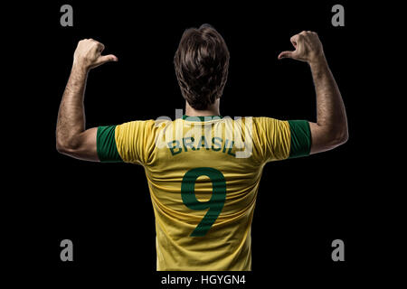 Brazilian soccer player, celebrating on a Black background. Stock Photo