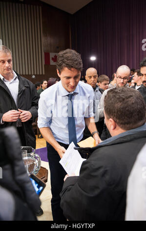 London, Canada, 13th January, 2017. Justin Trudeau, Prime Minister of Canada, talks to a recent Syrian refugee at the end of a town hall Q&A in the Alumni Hall of London's University of Western Ontario. London was one of his stops as part of his cross-country tour. Credit: Rubens Alarcon/Alamy Live News Stock Photo