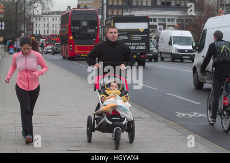 London, UK. 14th Jan, 2017. Pedestrian on Putney bridge on a cold morning as temperatures drop to freezing in London © amer ghazzal/Alamy Live News Stock Photo