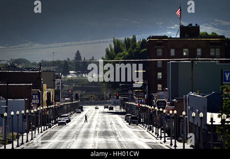 Ely, Nevada, USA. 12th July, 2016. A person stands in the middle of the trafficless Highway 50 photographing the Hotel Nevada in Ely, Nevada. The six-story hotel built in 1929, is a regular stop for tourists participating in Nevada's ''Loneliest Road'' program. Credit: David Becker/ZUMA Wire/Alamy Live News Stock Photo