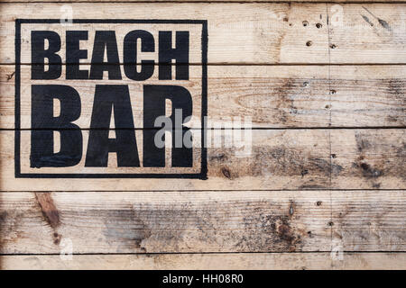 close up view of beach bar logo stamped on wooden surface Stock Photo