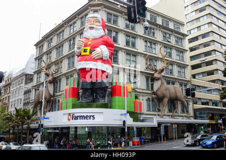 A giant Father Christmas on the front of a Farmers store in Auckland, New Zealand. Stock Photo