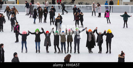 London, UK. Somerset House ice skaters sport colourful wigs created by the master hair stylist Sam McKnight, whose career in the fashion industry is currently being celebrated in the major exhibition 'Hair by Sam McKnight'. The exhibition runs until 12 March 2017, the ice rink is open until 15 January. Stock Photo