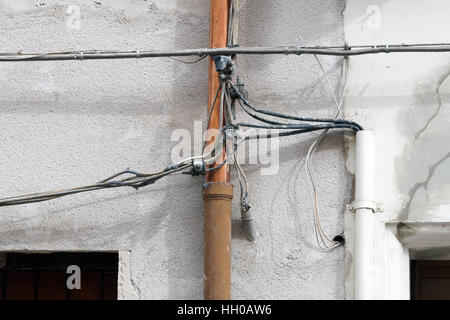 electric and telephone cables on the facade . Stock Photo