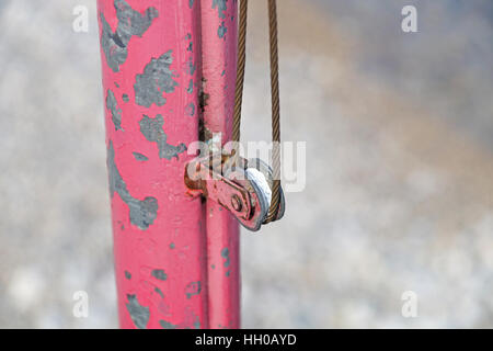 The rusty iron pulley with blue sky background . Stock Photo