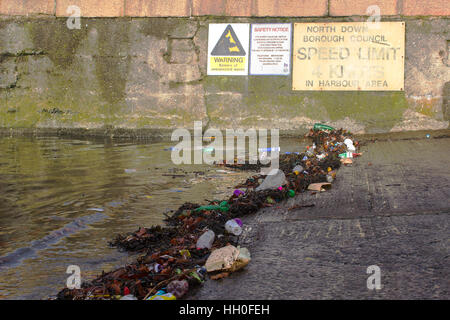 Plastic debris polluting a harbor slipway after a fierce storm in the Irish sea Stock Photo